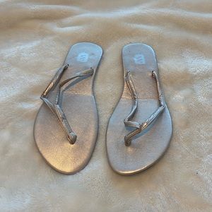 Rose gold flip flops